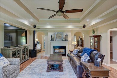 Living area with hardwood floors double sided fire