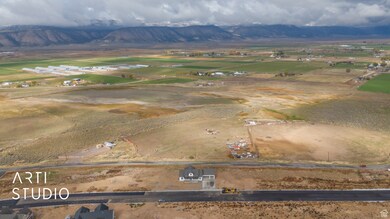 Aerial overview of property's location featuring a mountainous background and rural landscape
