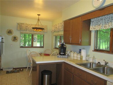 Kitchen has table area with plenty of windows givi