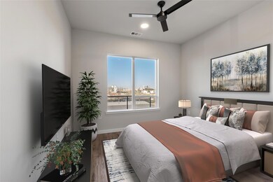 Bedroom with wood finished floors, a ceiling fan,