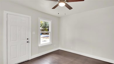 Foyer featuring dark wood-style floors and a ceiling fan