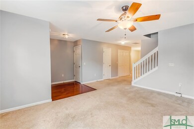 Partially open stair way and hallway to dining are