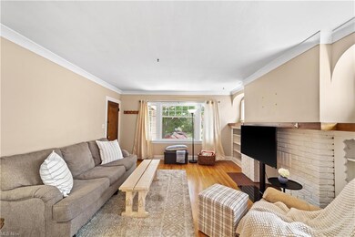 Living room with light hardwood floors and crown molding