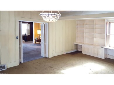 Louvered doors from living room lead to Library/Fa