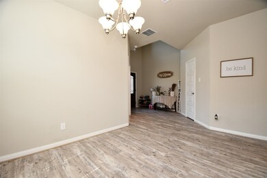 The room is enhanced by a chandelier.