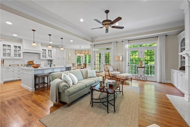 Living room with a ceiling fan, plenty of natural 