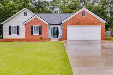 View of front of home with brick siding, concrete driveway, a front lawn, an attached garage, and a shingled roof