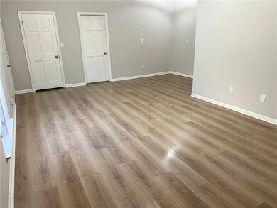 Spare room featuring light wood-style floors and baseboards
