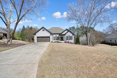 French country home featuring driveway, a front la