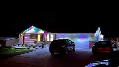 View of front of house featuring brick siding, covered porch, driveway, and an attached garage
