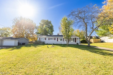 Ranch-style house featuring a detached garage