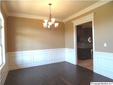 Dining room has 10 foot ceilings, hardwood flooring, shadow box below the chair rail.