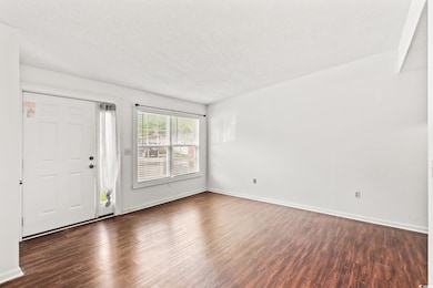 Entrance featuring a textured ceiling and wood finished floors