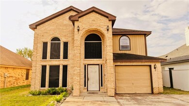 View of front of property with stone siding, an attached garage, a shingled roof, and driveway