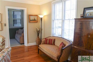 Living room leads to sunroom area.
