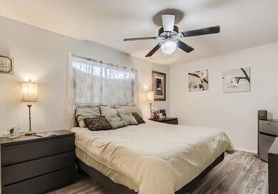 Bedroom with wood finished floors, stainless stee