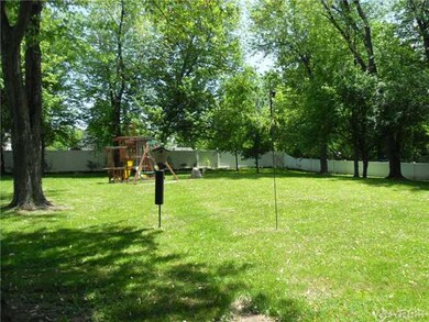 Yard. Beautiful treed fenced in yard with newer vi