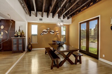 Spacious dining area featuring an exposed, truss c