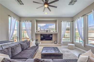 Living room featuring baseboards, a ceiling fan, a