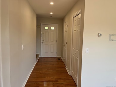 Front door with half bath and coat closet upon entry