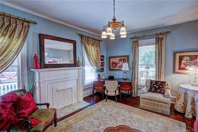Parlor with decorative fireplace, heart of pine fl