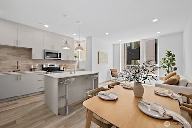 Great room with kitchen island! Model home. Colors and finishes may vary.