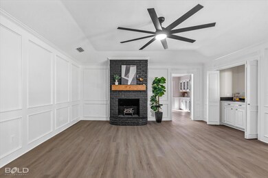 Unfurnished living room featuring a fireplace, woo