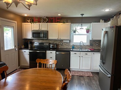 The new flooring in the eat in kitchen is beautifu