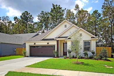 View of front of home featuring concrete driveway, a garage, and roof with shingles