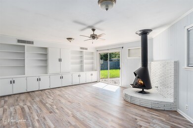 Unfurnished living room with a wood stove, crown m