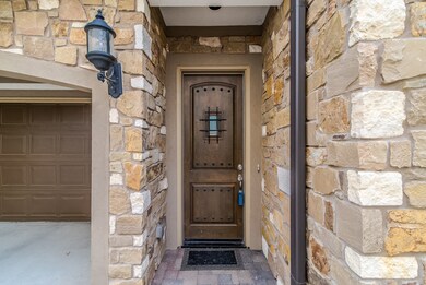 Stone and stucco exterior, coach lisghts, rain gut