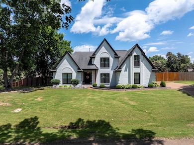 French provincial home featuring brick siding
