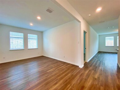 Spare room with dark hardwood / wood-style floors and a healthy amount of sunlight