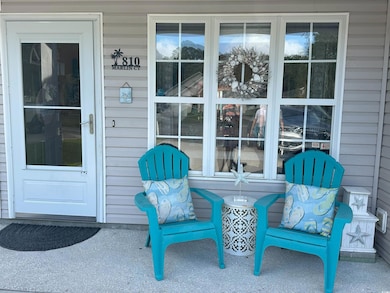 Enjoy the front porch for visiting with the neighbors or unwinding after a long day at the beach
