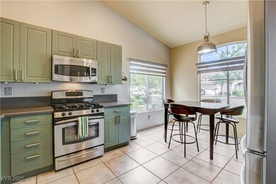 Kitchen with stainless steel appliances, green cab