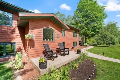 View of side of property with a lawn and a deck