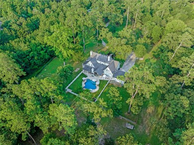 Large lush trees and landscaping provide ample privacy and peacefulness in this stunning luxury home