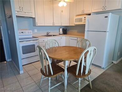 Kitchen featuring white appliances, under cabinet