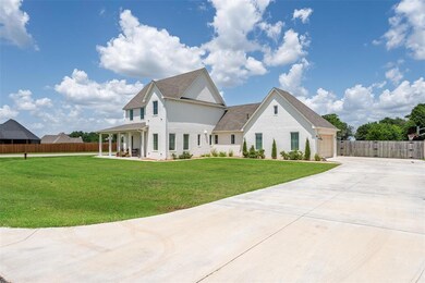 View of front of house featuring brick siding, concrete driveway, an attached garage, and roof with shingles