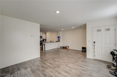 Living room with light wood finished floors, reces
