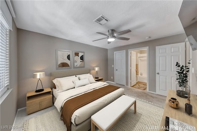 Bedroom with multiple windows, light colored carpe