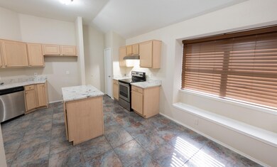 Kitchen with stainless steel appliances, light bro