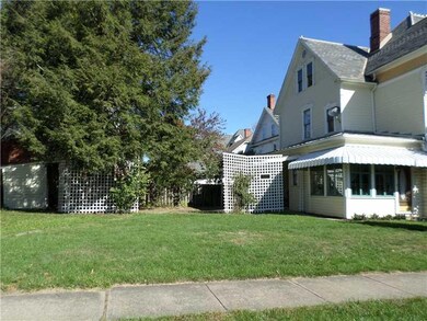 View. Corner lot with patio and covered rear porch