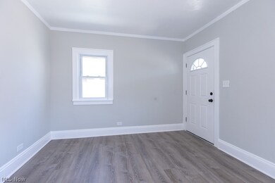 Foyer entrance featuring ornamental molding and hardwood / wood-style floors
