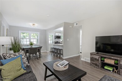 Living area with light wood-style flooring and baseboards