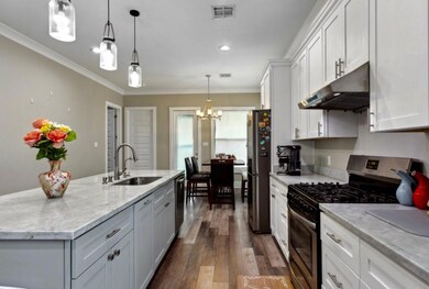 Open kitchen with oversized island looking into th