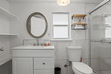 Bathroom with walk in shower, toilet, and vanity
