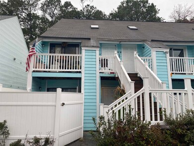 View of front of property featuring stairway, roof