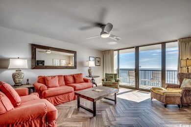 Living room featuring ceiling fan, a water view, a