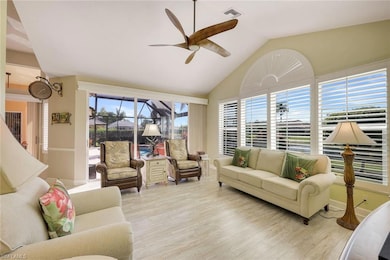Overlooking the pool and lake, this family room/den offers vaulted ceilings and stunning views.